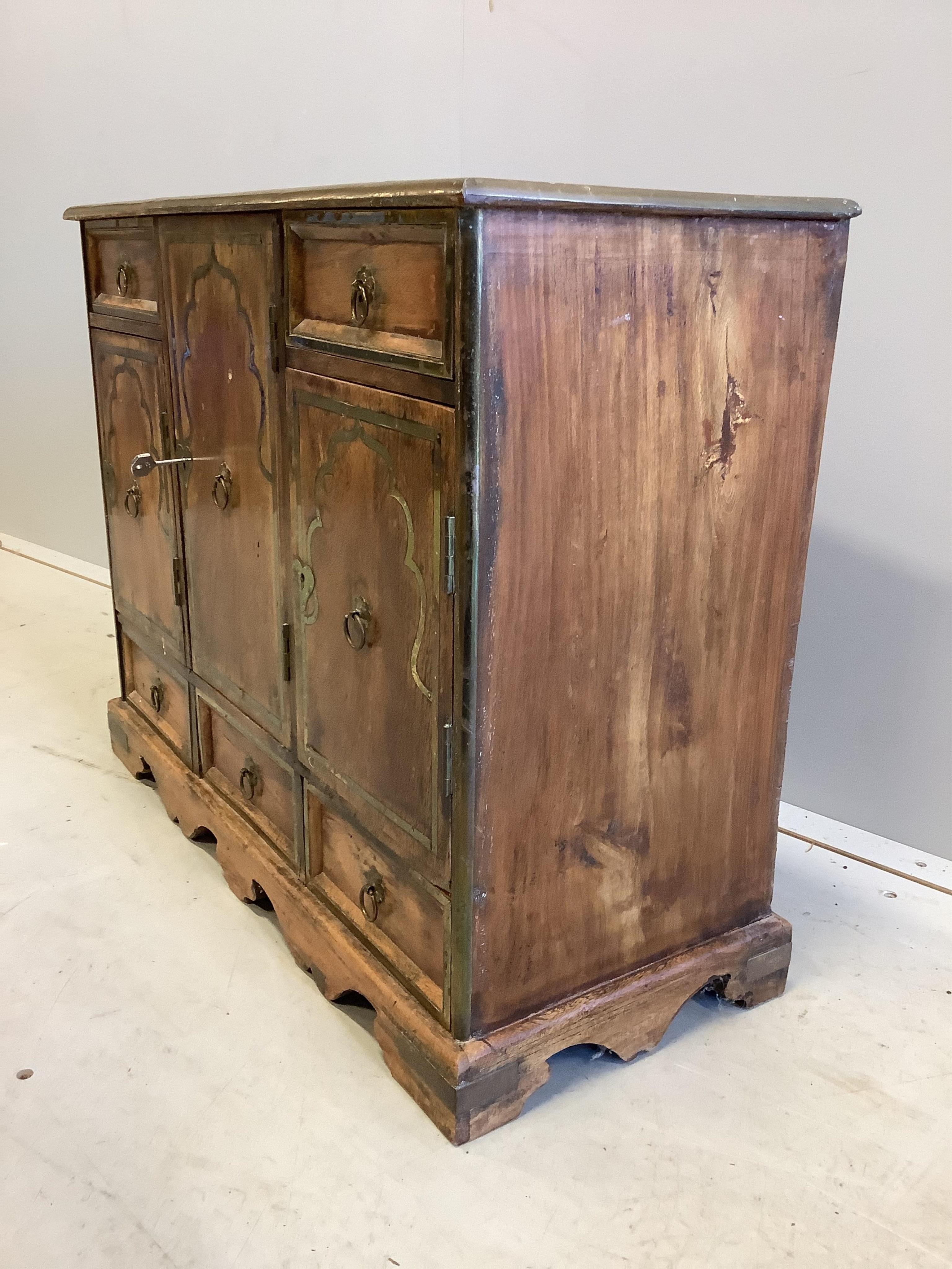 An unusual small Continental brass inlaid cabinet, fitted with three cupboards and five drawers, width 62cm, depth 25cm, height 50cm. Condition - fair